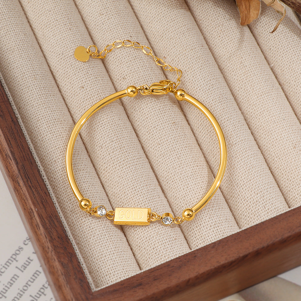 Damen Armband mit funkelnden Kristallakzenten und modernem GOLD-Anhänger Shop Nory