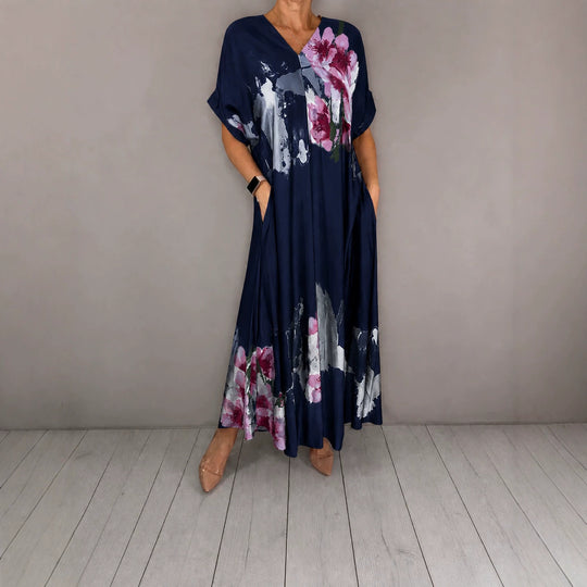 Damen Maxikleid mit weitem Fall, V-Ausschnitt, Eingrifftaschen und floraler Aquarelloptik Shop Nory