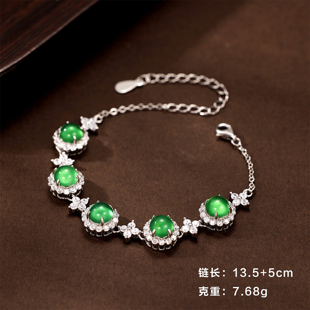 Damen Armband mit funkelnden Kristallen und grünem Edelstein Shop Nory