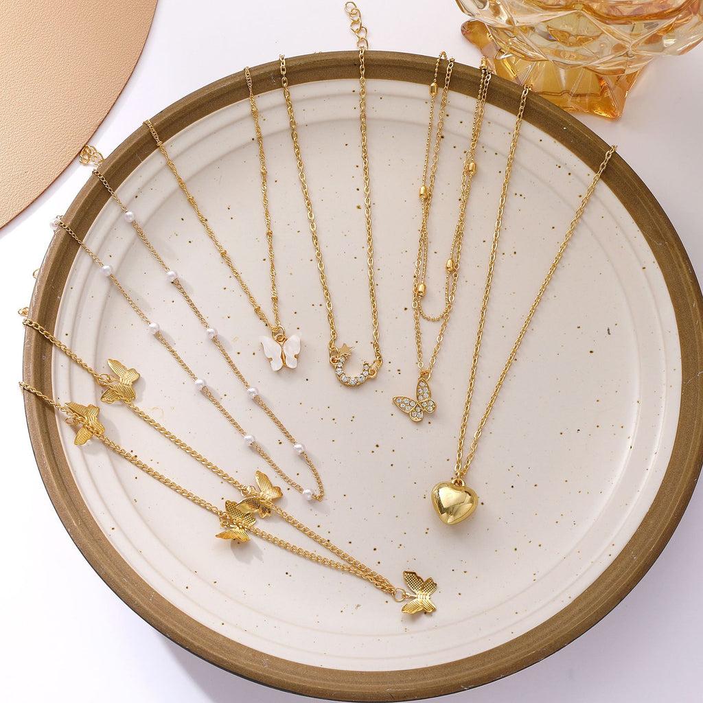 Damen Halskette Set aus feinen goldenen Ketten mit verspielten Anhängern Shop Nory