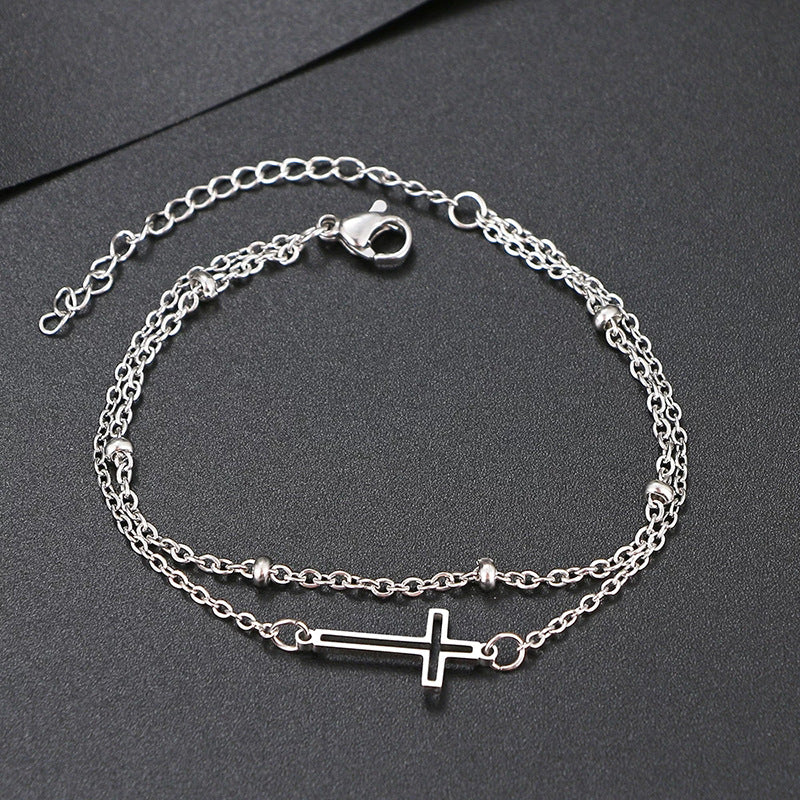 Damen Armband mit filigranem Kreuzdesign und elegantem Kettenspiel Shop Nory