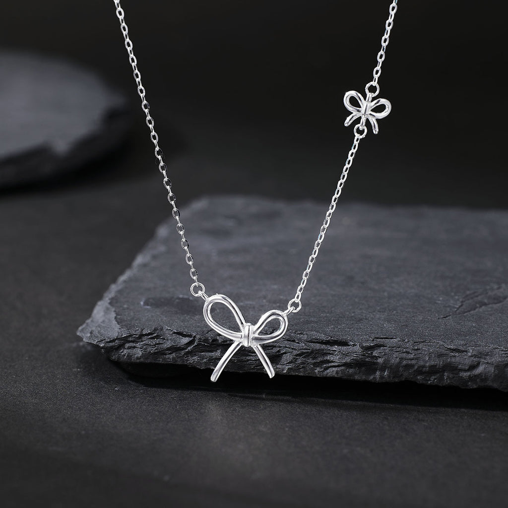 Damen Halskette mit kunstvollem Schleifenanhänger und feiner Gliederkette Shop Nory