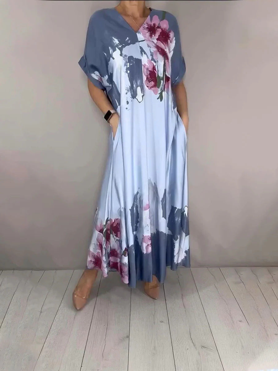 Damen Maxikleid mit weitem Fall, V-Ausschnitt, Eingrifftaschen und floraler Aquarelloptik Shop Nory