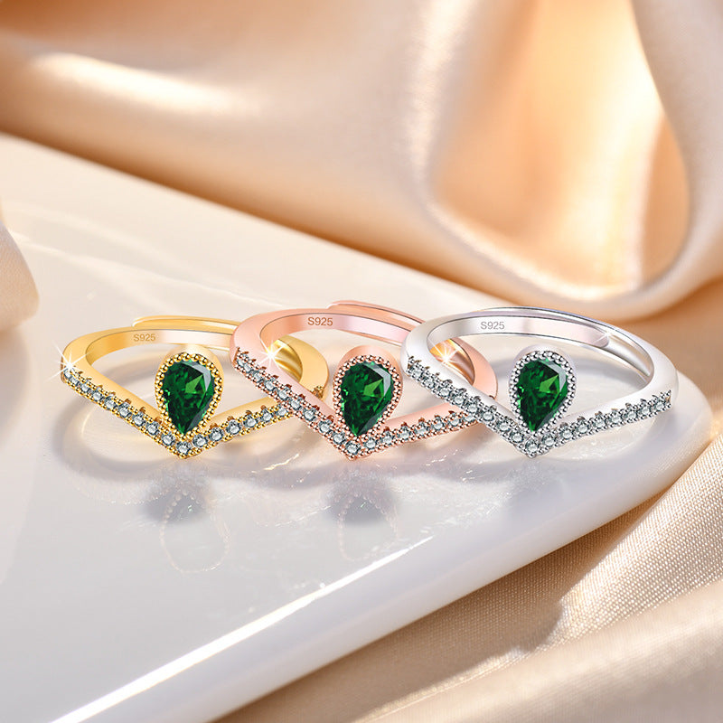 Damenring mit tropfenförmigem grünem Edelstein und Zirkonia-Besatz Shop Nory