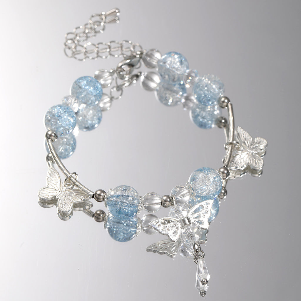 Damenarmband mit funkelnden Glaskugeln und filigranen Schmetterlingen Shop Nory