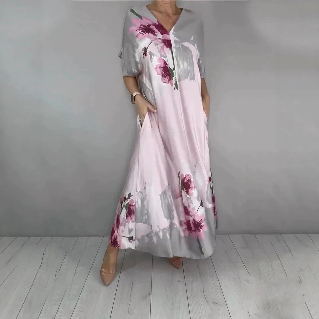 Damen Maxikleid mit weitem Fall, V-Ausschnitt, Eingrifftaschen und floraler Aquarelloptik Shop Nory