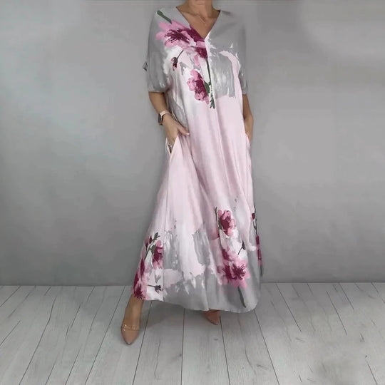 Damen Maxikleid mit weitem Fall, V-Ausschnitt, Eingrifftaschen und floraler Aquarelloptik Shop Nory