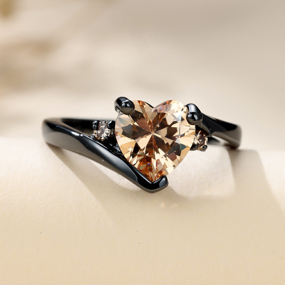 Damen Ring mit herzförmigem blauen Zirkonstein und eleganter schwarzer Fassung Shop Nory