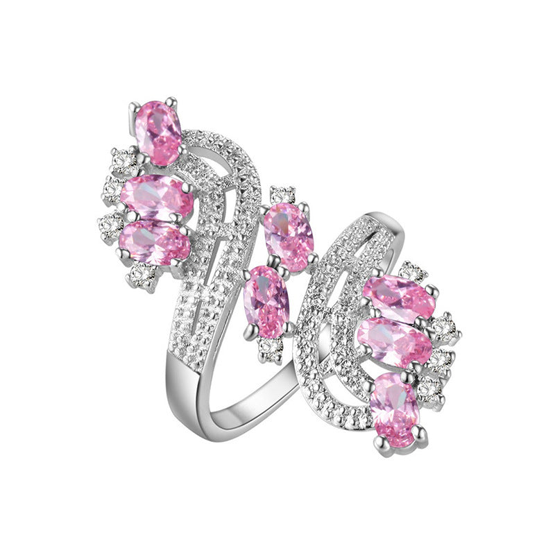Damenring mit kunstvollem Wellenmuster und eleganten rosa Kristallen Shop Nory