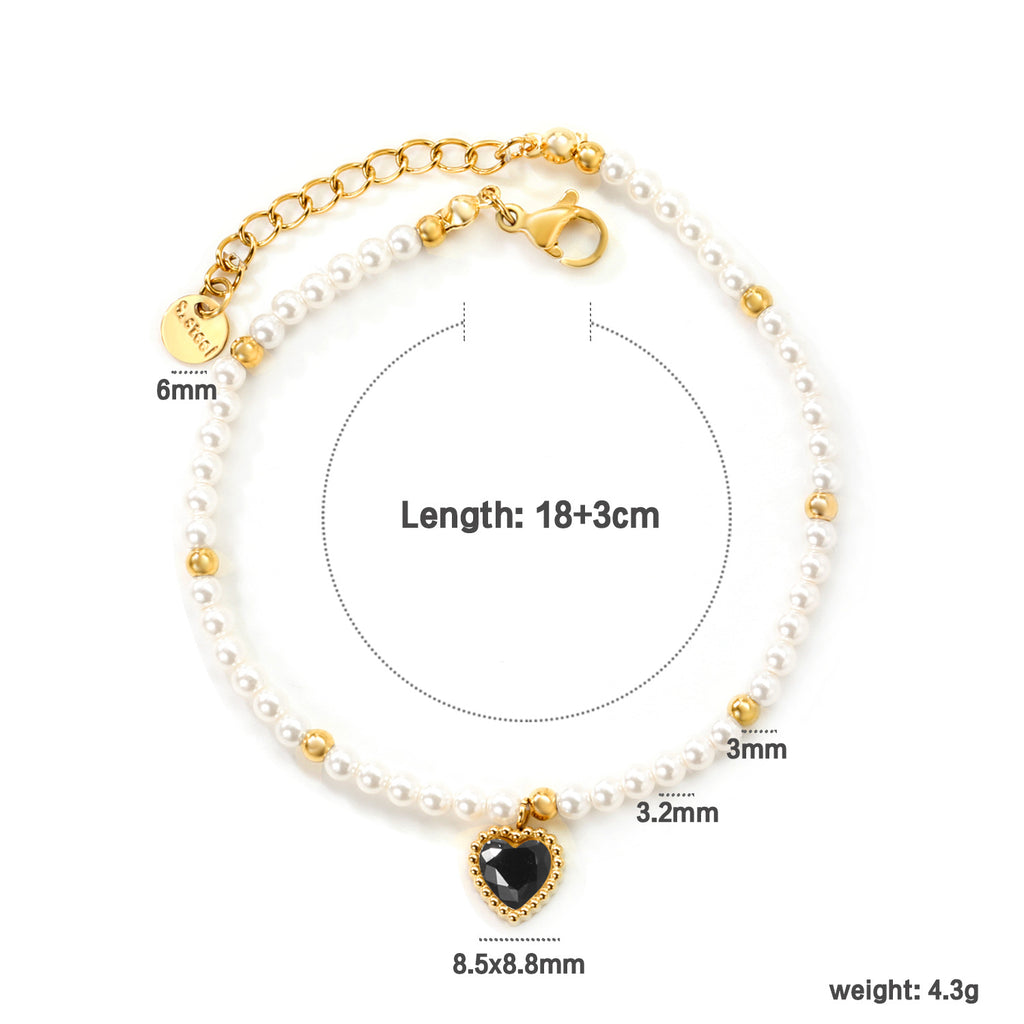 Damen Armband mit schimmernden goldenen Perlen und funkelndem Herzanhänger Shop Nory