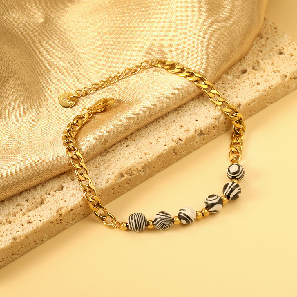 Damen Armband mit glänzender Gliederkette und elegantem Zebra-Muster Shop Nory