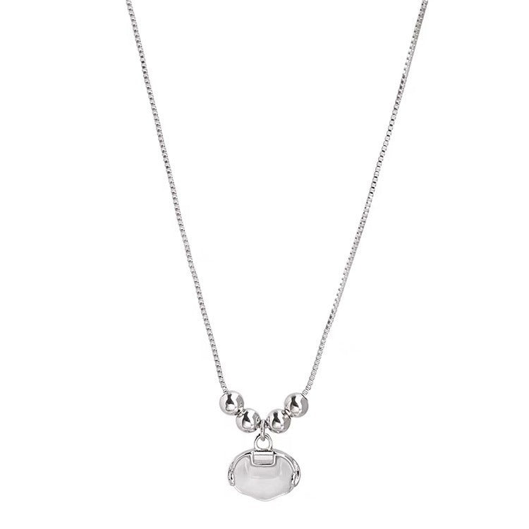 Damen Halskette mit elegantem, ovalem Anhänger und funkelnden Perlendetails Shop Nory
