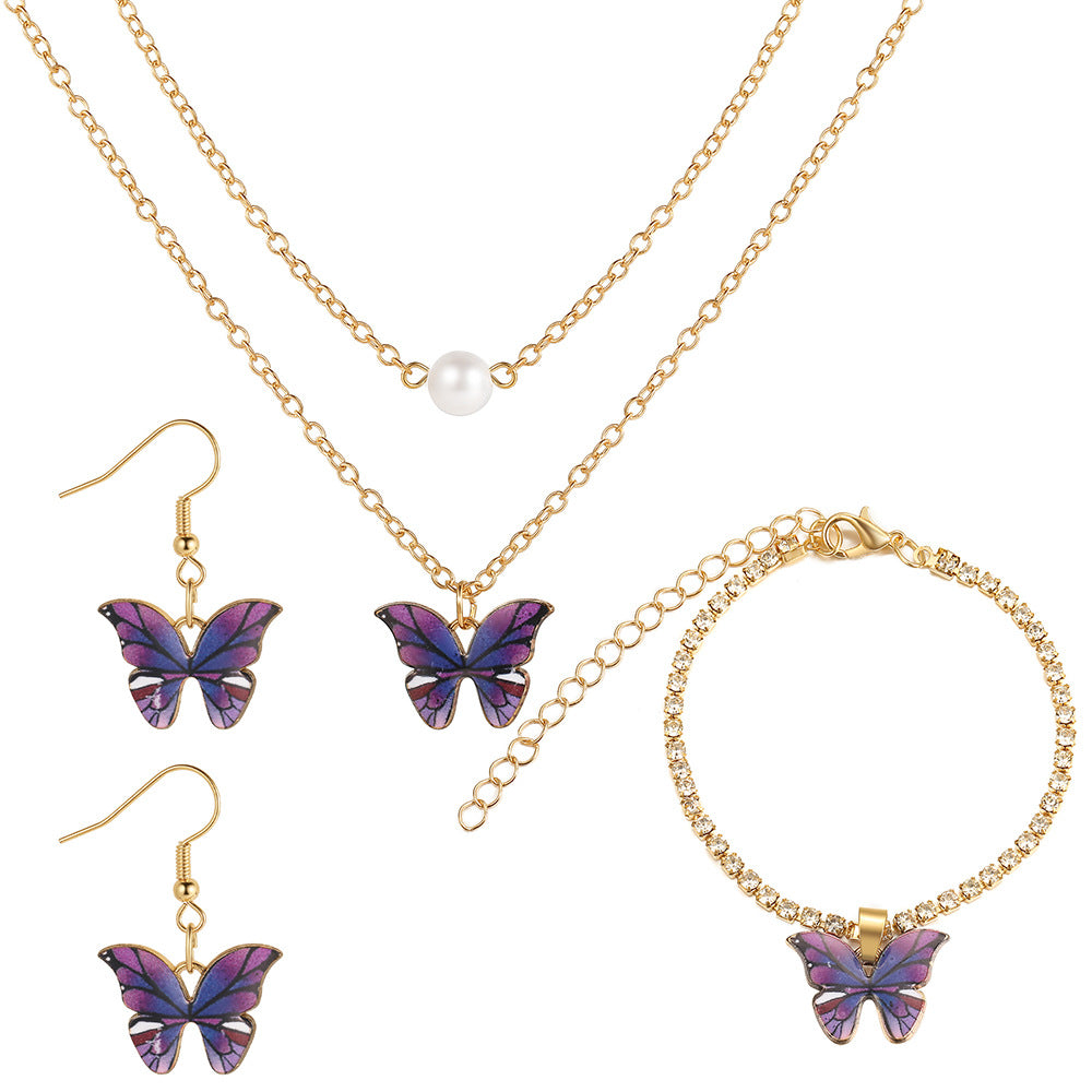 Damen Schmuckset mit schimmernden Schmetterlingsanhängern und funkelnden Elementen Shop Nory