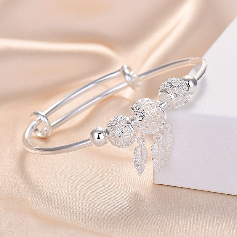 Damenarmband mit kunstvollen Perlen und zarten Federmotiven Shop Nory