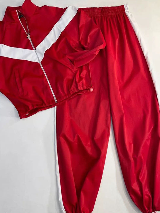 Damen tailliertes Zip-Trainingsset mit Chevron-Einsatz, Kordelzugsaum und hochgeschnittener Jogginghose Shop Nory