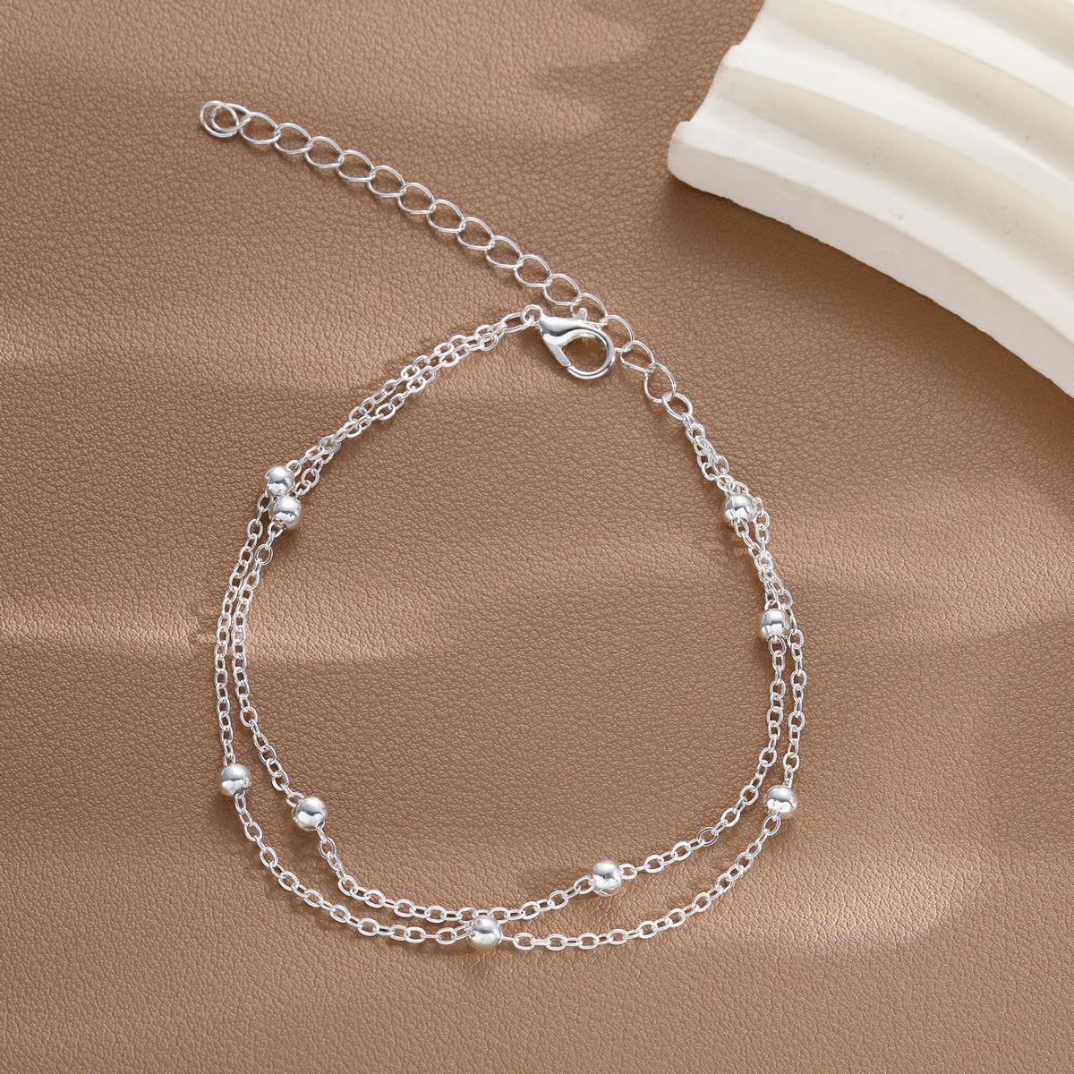 Damenarmband mit modischem Doppelketten-Design und eleganten Metallakzenten Shop Nory