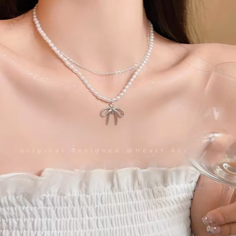 Damen Halskette mit luxuriösen Perlen und filigranem Schleifenanhänger Shop Nory