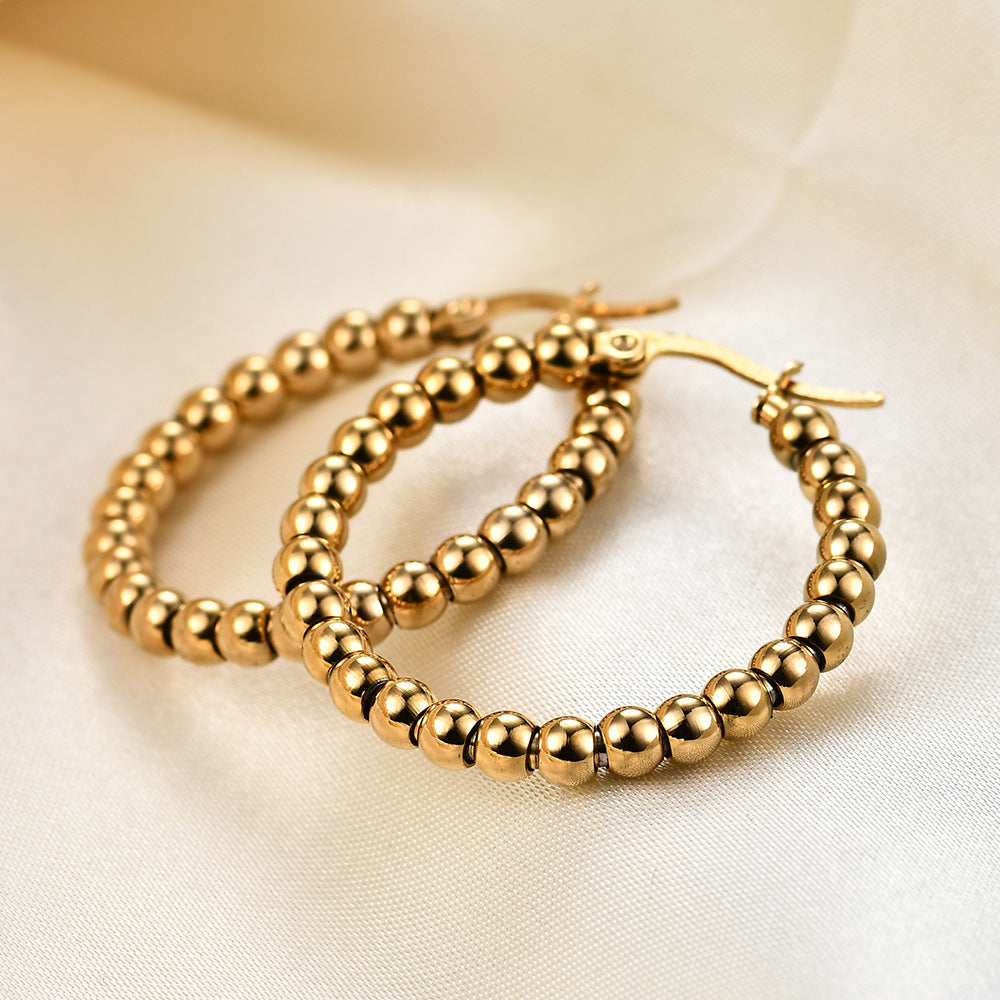 Damen Creolen aus hochwertigem Edelstahl mit glänzenden Kugeldetails Shop Nory