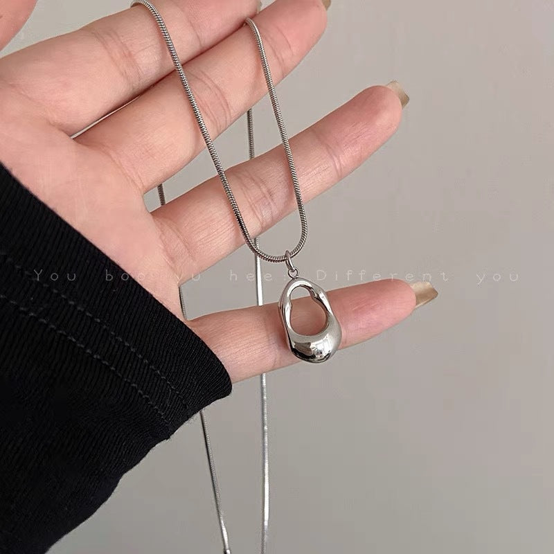 Damen Halskette mit modernem, geschwungenem Anhänger aus hochwertigem Edelstahl Shop Nory