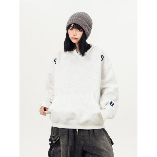 Unisex Oversized Kapuzenpullover mit großflächigem Intarsien‑Blockprint und geripptem Saum Shop Nory
