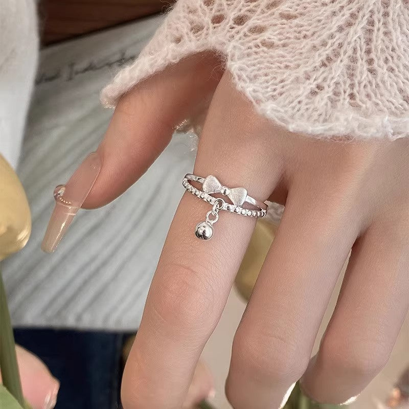 Damen filigraner Ring mit verspieltem Schleifen- und Glöckchen-Design Shop Nory