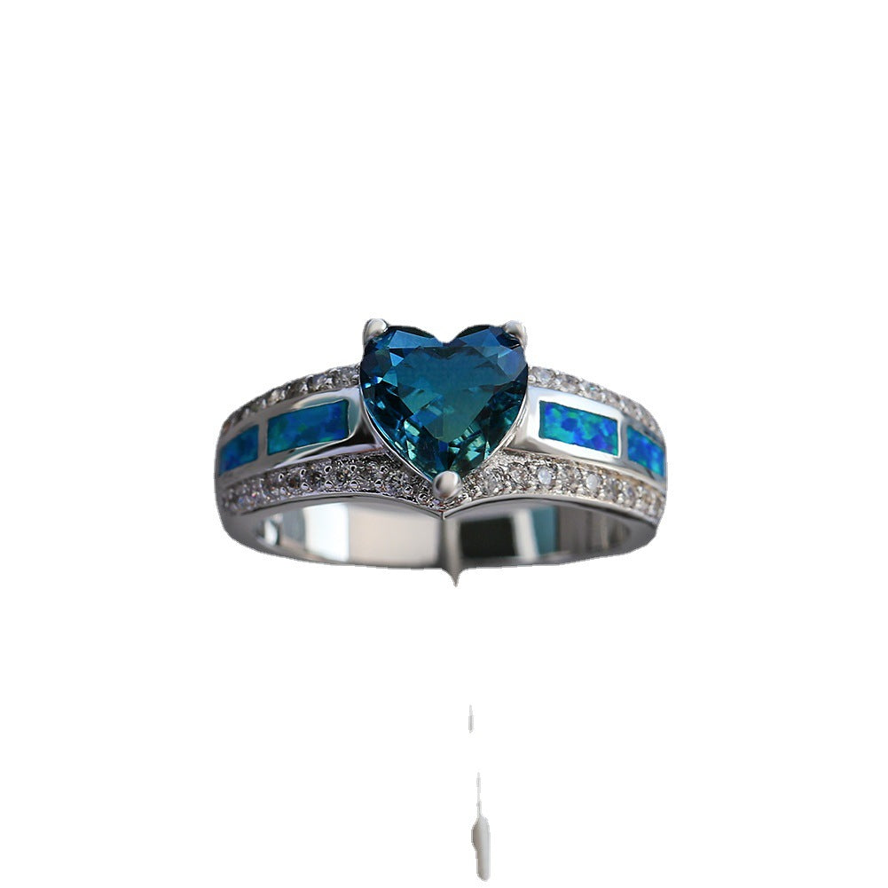Damen Ring mit herzförmigem smaragdgrünem Stein und feinen Zirkonia-Details Shop Nory