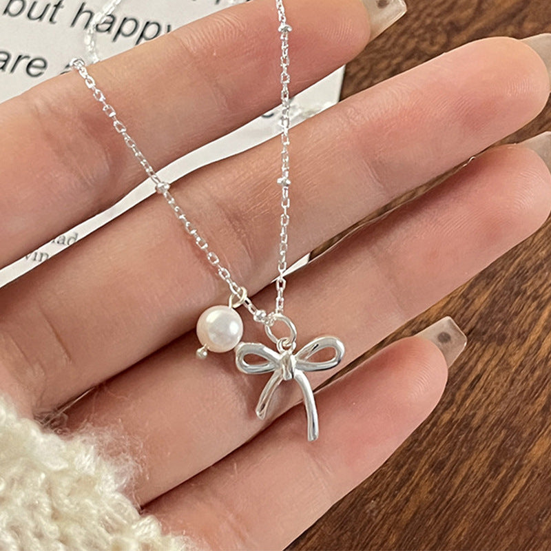 Damen Kettenanhänger mit Schleifenmotiv und Perle Shop Nory