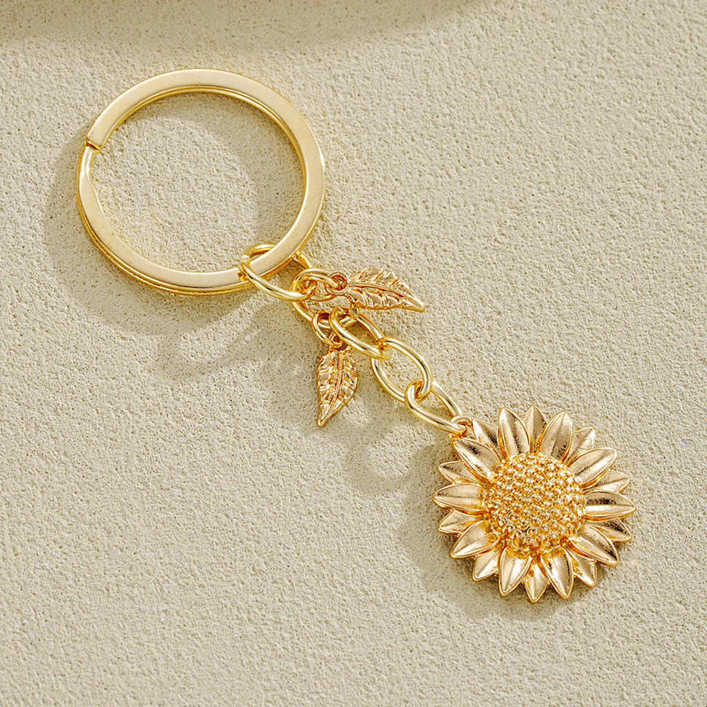 Damen Schlüsselanhänger mit filigranem Sonnenblumen-Design und elegantem Blattakzent Shop Nory