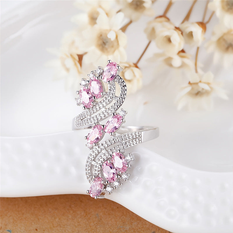 Damenring mit kunstvollem Wellenmuster und eleganten rosa Kristallen Shop Nory