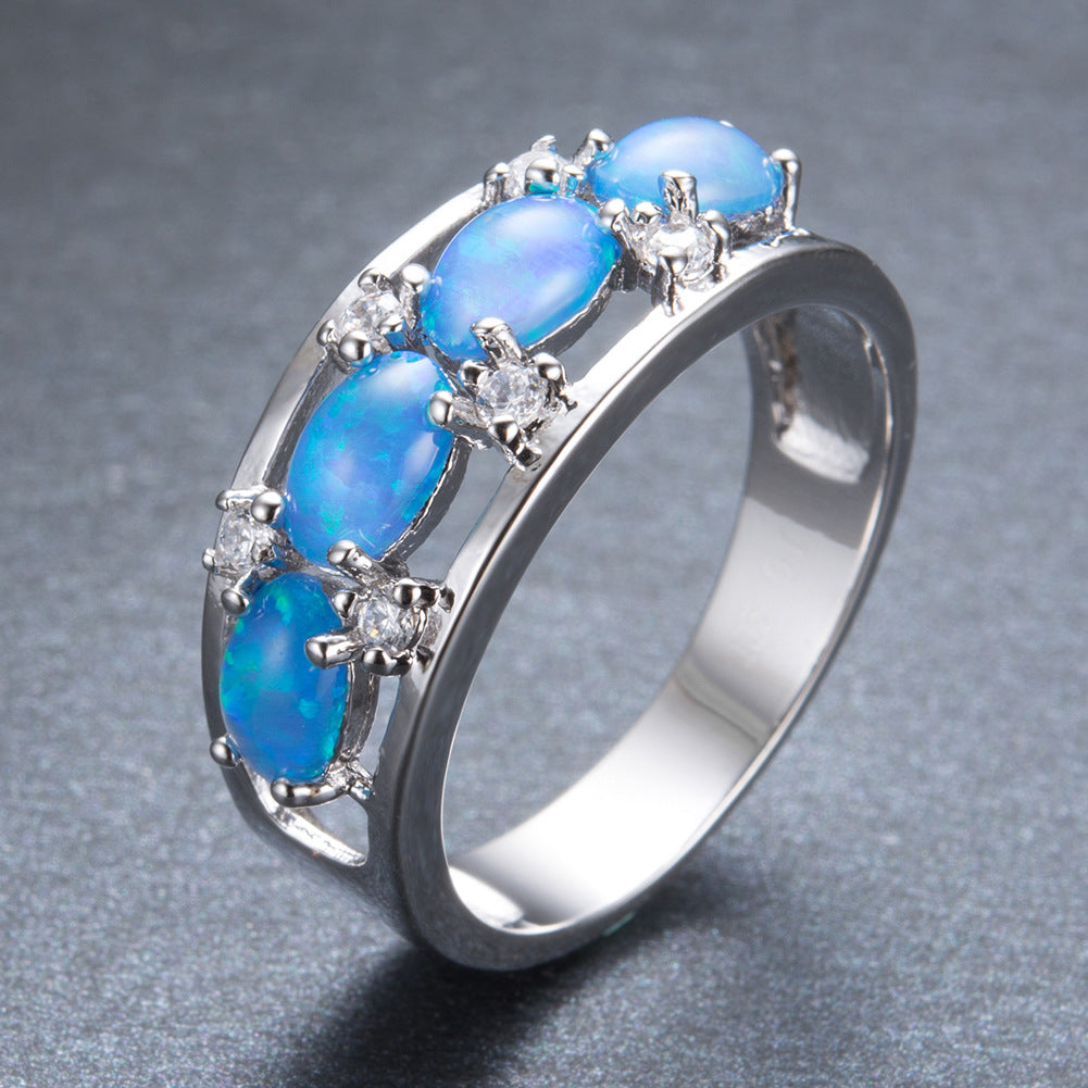 Damen Ring mit leuchtenden Opalsteinen und funkelnden Zirkonia-Elementen Shop Nory