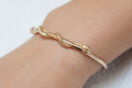 Vergoldetes Armband mit ineinandergreifendem Schlangenmotiv – Symbolische Eleganz | Shop Nory