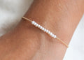 Armband mit 12 weißen Perlen - 16K vergoldet | Shop Nory
